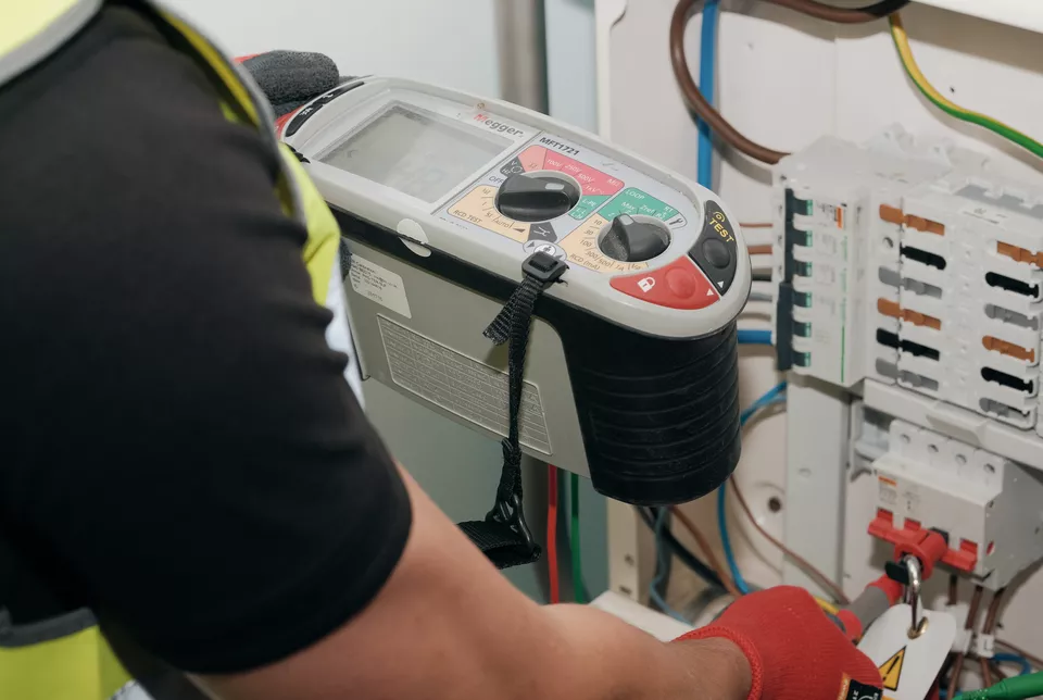 A First Certify Electrician conducting an EICR on a consumer unit in a property in London